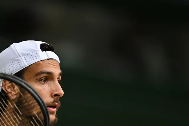 Lorenzo Musetti waits to receive a serve