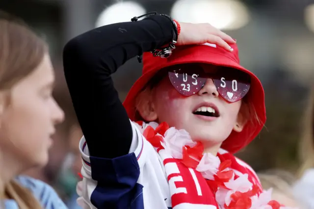 A young fan with Russo branded glasses and a bucket hat