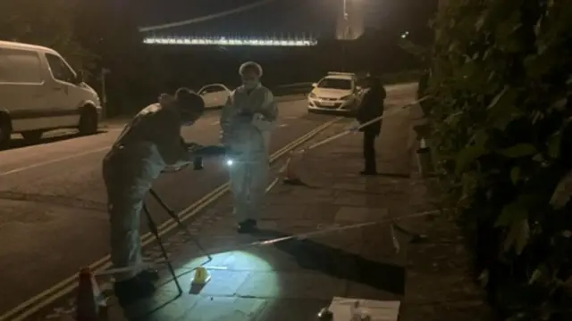 Forensics team near the suspension bridge in Sion Hill