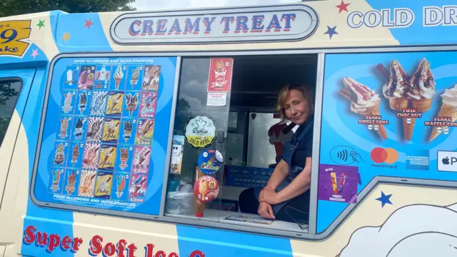 Graziella Licata. She is blonde and sat in an ice cream van.