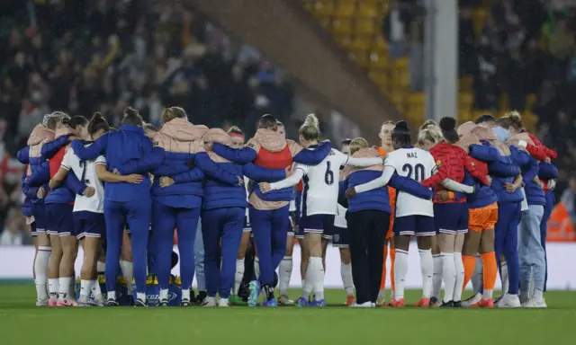 England gather on the pitch at full time