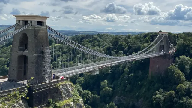 Clifton Suspension Bridge in Bristol. The bridge has two tall towers at each end. Trees can be seen below the bridge.