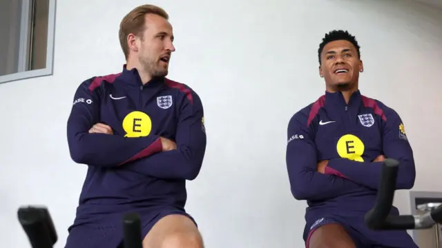 Harry Kane and Ollie Watkins of England talk in the gym at Spurs Lodge on June 04, 2024 in London, England.