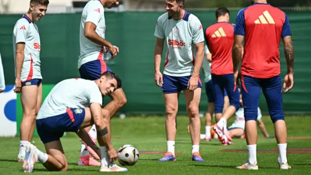 Alvaro Morata ties his bootlaces during a Spain training session at Euro 2024