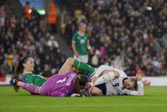 Russo and Brosnan collide as they challenge for the ball