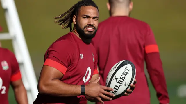 Chandler Cunningham-South holds a ball during an England training session