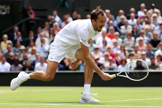 Daniil Medvedev plays a forehand against Carlos Alcaraz