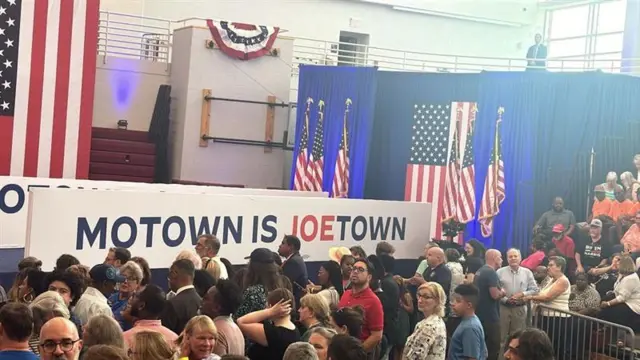 People stand in front of a banner that reads "Motown Is Joetown"