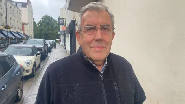 Barry Smith. He has short grey hair and glasses. He is wearing a dark fleece. He is pictured looking directly at the camera with a smile.