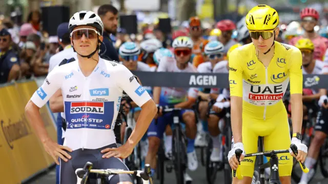 Remco Evenepoel and Tadej Pogacar waiting on their bikes at the start line during the 2024 Tour de France