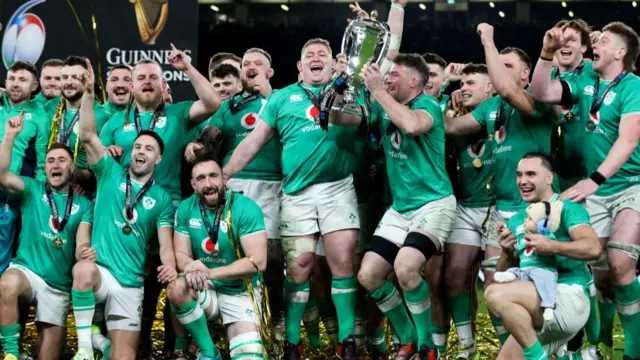 Ireland players celebrate with Six nations trophy