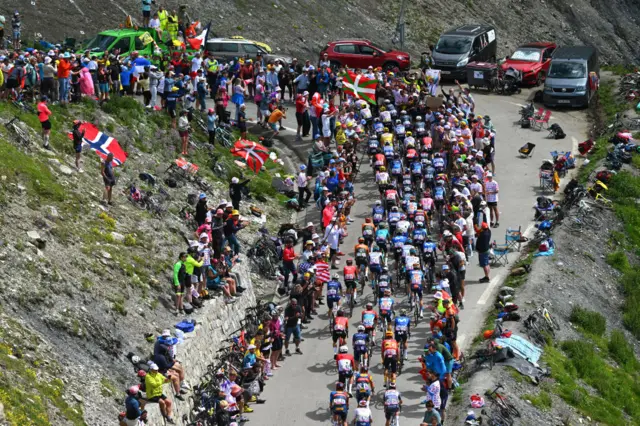 General view of the peloton climbing the Hourquette d'Ancizan on stage 14 of the 2024 Tour de France