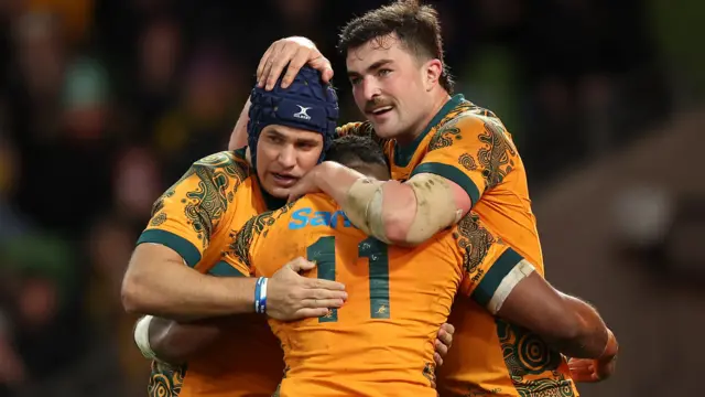 Australian players celebrate opening try