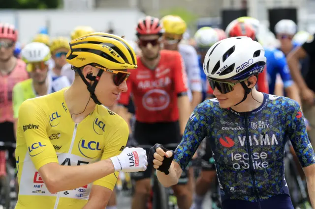 Tadej Pogacar and Jonas Vingegaard bump fists before the start of a stage at the 2024 Tour de France