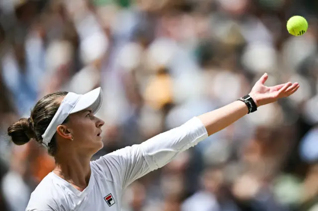 barbora krejcikova throws the ball to serve