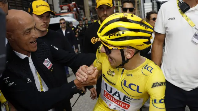 Tadej Pogacar celebrates with his team after winning stage 14 of the 2024 Tour de France