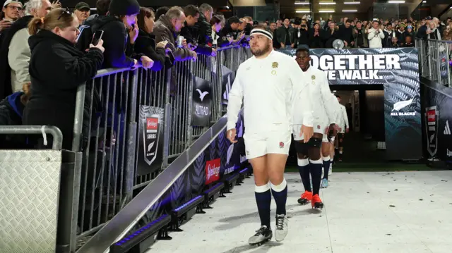 Jamie George leads out the England team