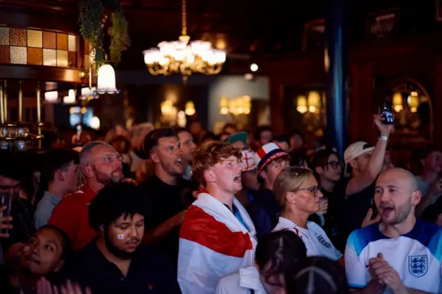 England fans cheer in a pub in London