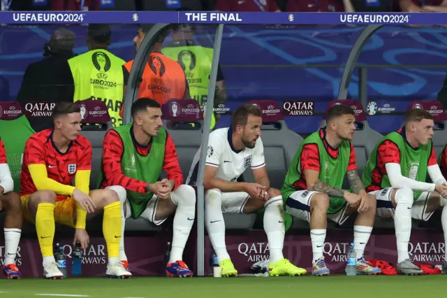 kane sits glumly on the bench after being replaced