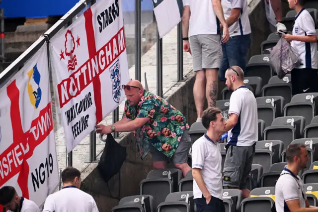 England fans hang flags in the ground