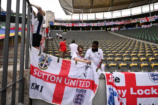 England fans hang flags in the ground