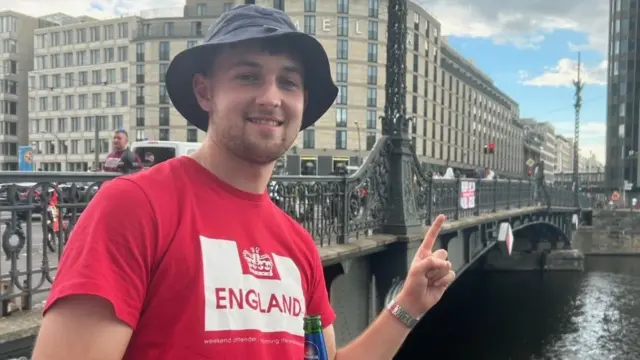 England fan Jacob points to an England flag in Berlin