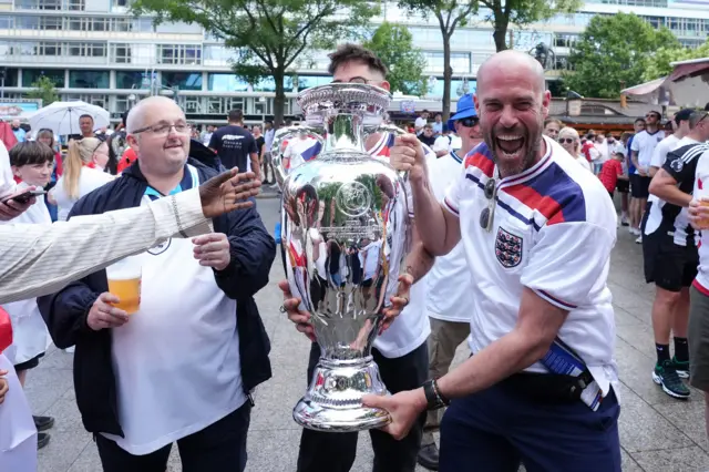 England fans with a replica trophy