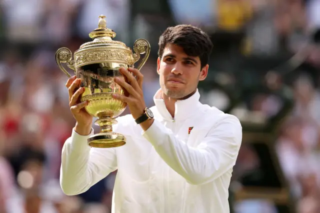 carlos alcaraz with the wimbledon trophy