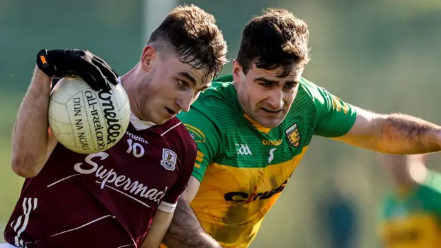 Galway's Matthew Tierney is challenged by Donegal midfielder Caolan McGonagle