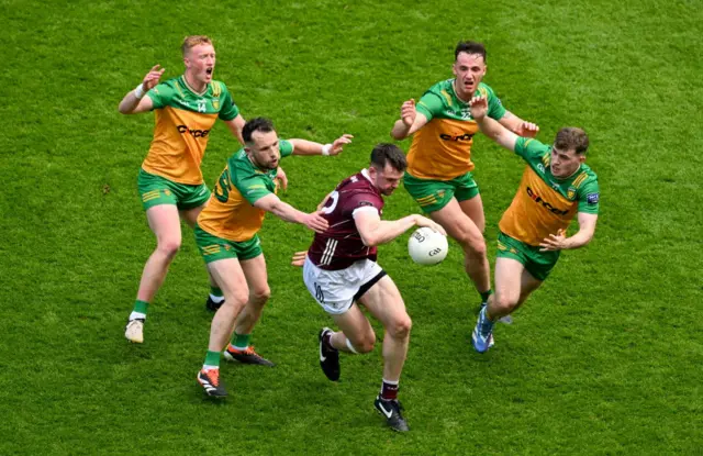 Galway's Cein Darcy gets close attention from four Donegal players