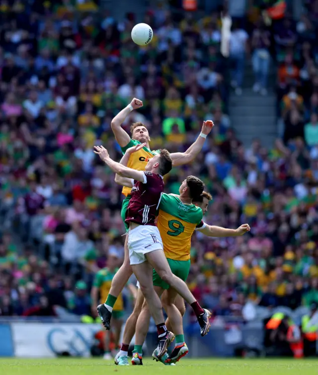 Donegal duo Jason McGee and Michael Langan contest the high ball with Matthew Tierney