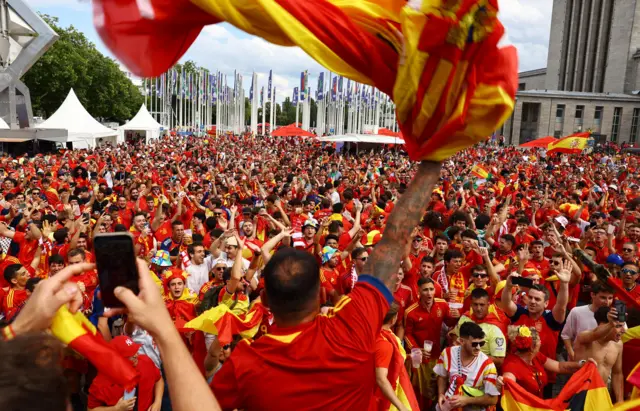 Spanish fans gather and sing ahead of the match