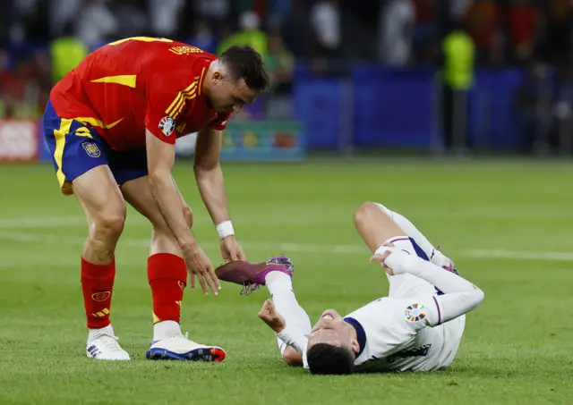 Foden is checked on by Ruiz after a late clash