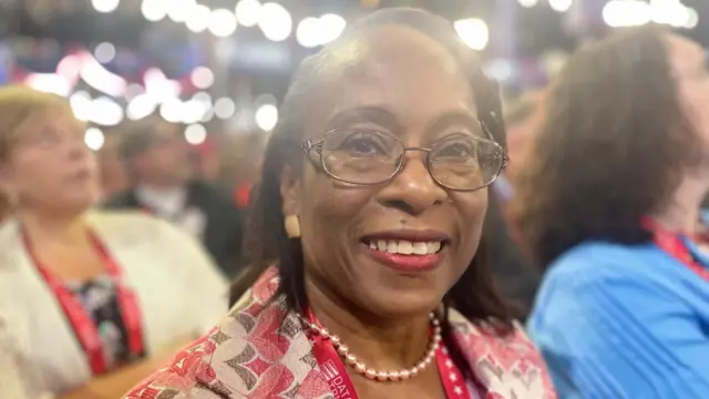 Dr Elizabeth Hinds-Ferrick smiles at the camera in a crowd