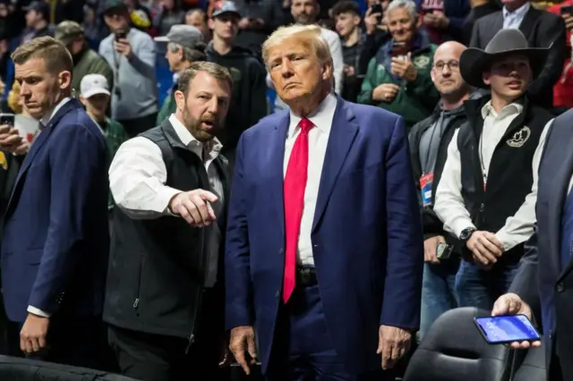 US Senator Markwayne Mullin talks with former President Donald Trump during a wrestling event in 2023