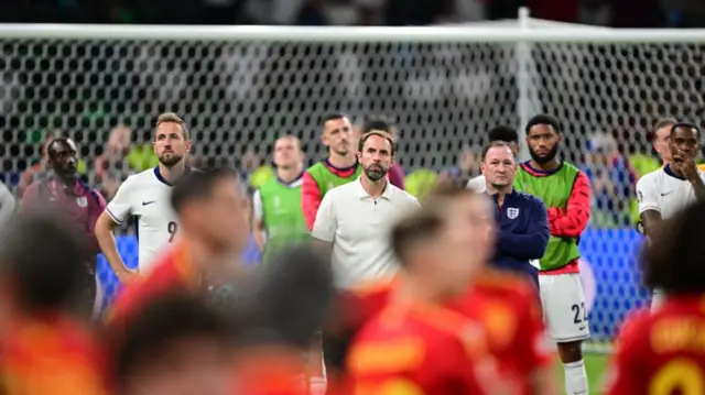 Harry Kane and Gareth Southgate watch the Spain team celebrate