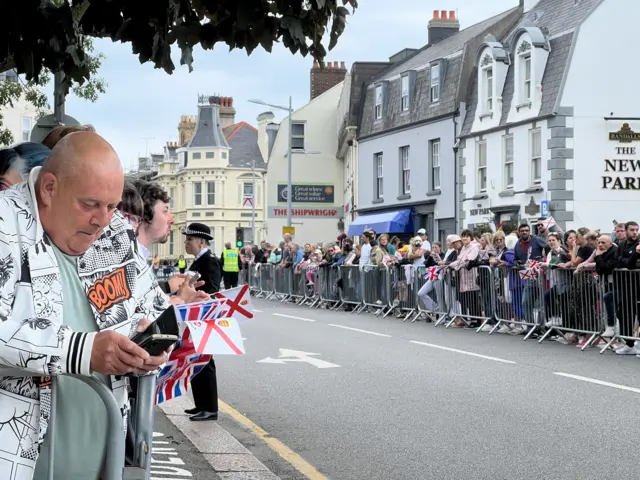 Crowds behind barriers in St Helier