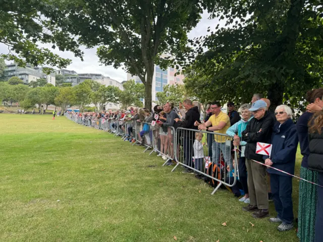 Crowds behind a barrier in Jersey