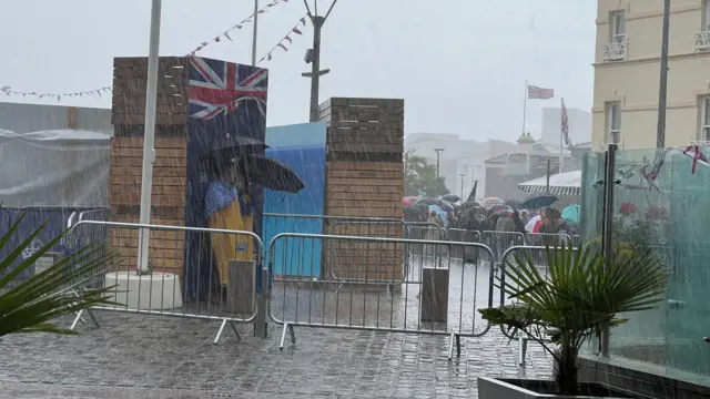 Downpour with people sheltering