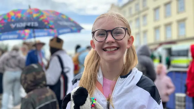 Smiling girl in a crowd of people