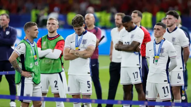 Kieran Trippier, Jarrod Bowen, John Stones, Ivan Toney, Phil Foden and Declan Rice of England look dejected after the UEFA EURO 2024 final match between Spain and England at Olympiastadion on July 14, 2024 in Berlin, Germany.