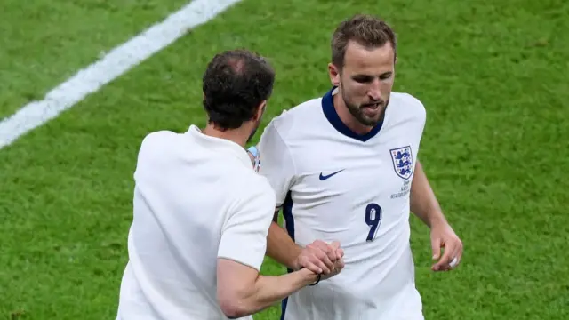 Gareth Southgate, Head Coach of England, shakes hands with Harry Kane of England as he leaves the field after being replaced by substitute Ollie Watkins (not pictured) during the UEFA EURO 2024 final match between Spain and England at Olympiastadion on July 14, 2024 in Berlin, Germany.