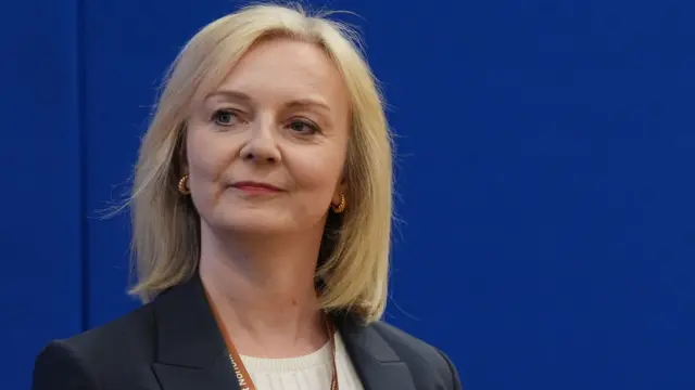 Liz Truss looks to the side