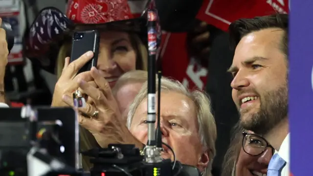 A man takes a selfie with vice-presidential nominee JD Vance