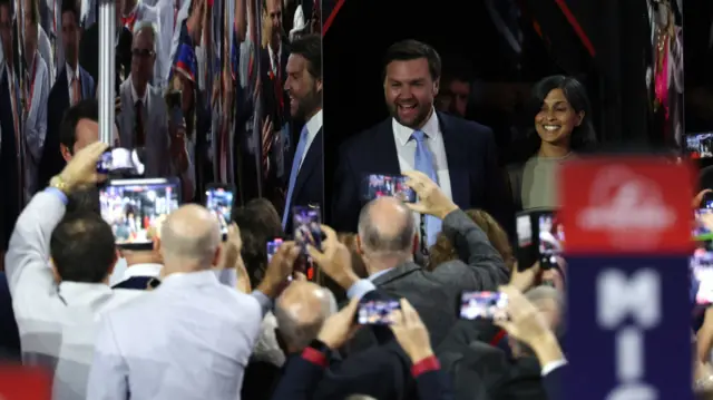 A crowd take pictures of JD Vance as he and his wife at the convention