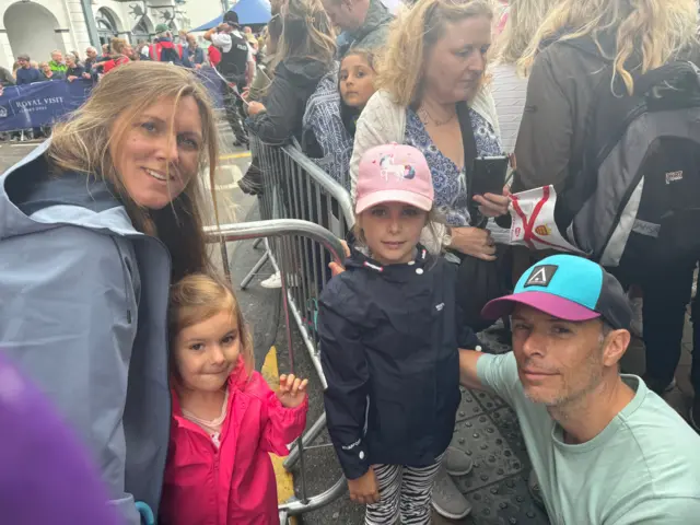 Family of four behind barrier for royal visit