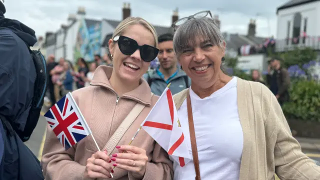 Two woman holding flags