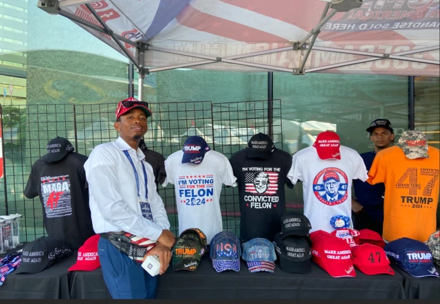 Trump merchandise vendor Anthony Montgomery with his best-selling shirts.