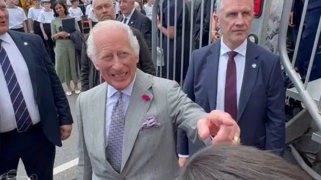 King Charles pointing into the crowd