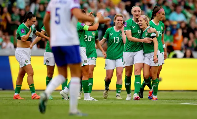 The Irish players celebrate Denis O'Sullivan's goal